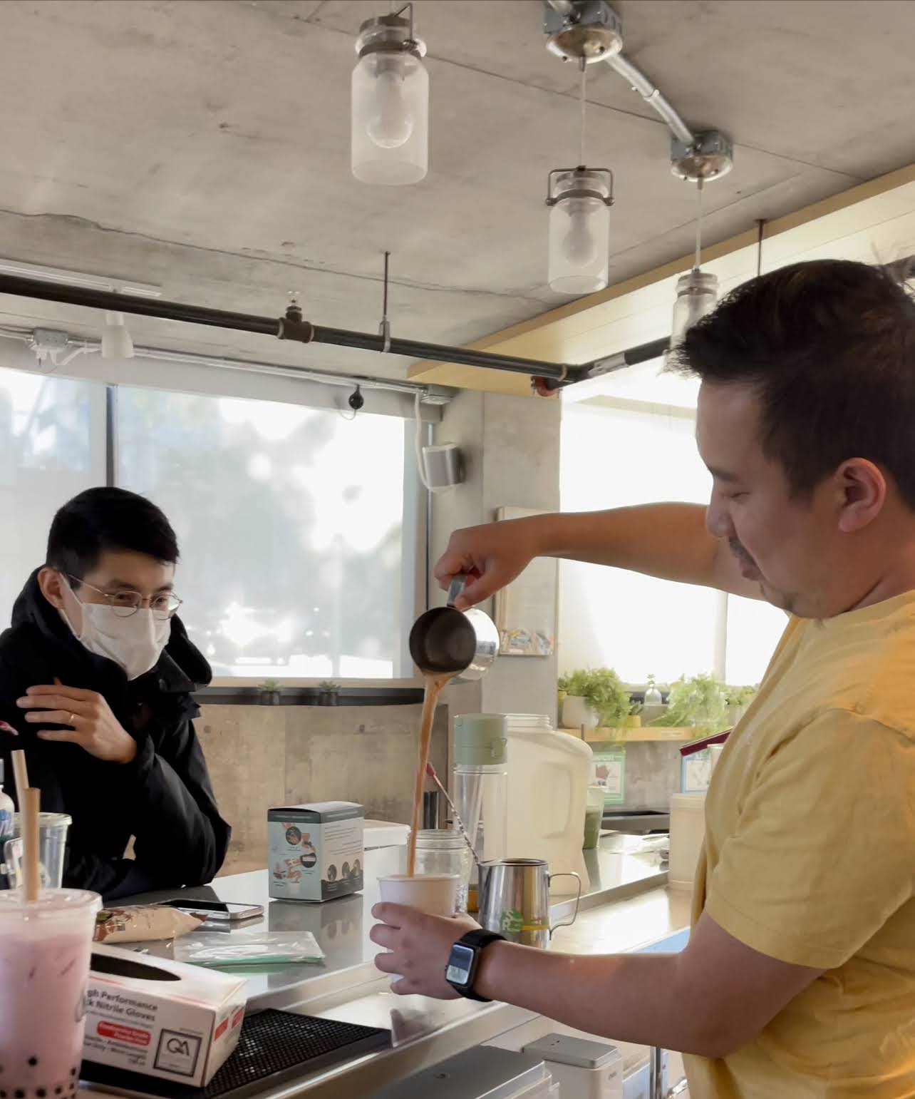 pouring chai into a cup to drink